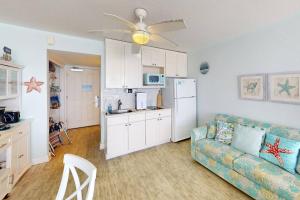 a living room with a couch and a kitchen at 318 - Island Inn in St. Pete Beach