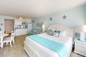 a bedroom with a large bed and a kitchen at 318 - Island Inn in St. Pete Beach