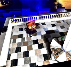 a table with a fireplace on a checkered floor at Appartement S3 CHIC à Mahdia 2étages in Mahdia +5 photos