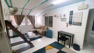 a living room with a couch and a table at Simple2 Guesthouse in Pantai Cenang
