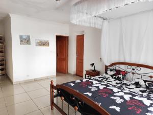 Rúm í herbergi á Villa Manamé, face à l'océan