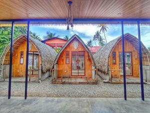 a painting of three houses with their doors open at Casita Agnes Private Resort in Boac +12 photos
