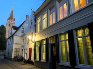 a group of buildings on a street with a cathedral at Brugge G13 in Bruges