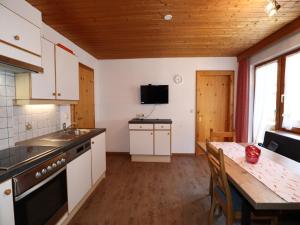 a kitchen with a table and a counter top at Apartment in See near Bathing Lake in See