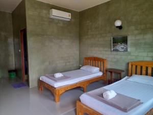 Katil atau katil-katil dalam bilik di Jayzada Fang Resort เจซาด้า รีสอร์ท