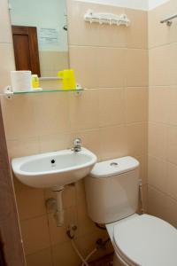 a bathroom with a toilet and a sink at Andrea Hotel in Yogyakarta