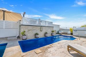a swimming pool in the backyard of a house at 'Central Plaza' Adjacent Apartments with Rooftop Pool in Cairns