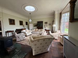 a large living room with couches and chairs at Shannon River House & Gardens in Limerick