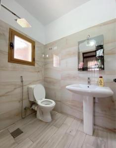 a bathroom with a sink and a toilet at Arlind's Apartaments in Vlorë