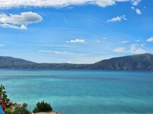 a view of a large body of water with mountains at Arlind's Apartaments in Vlorë
