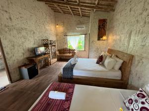 a bedroom with a bed and a couch in a room at D'Nanda mini hotel Ubud in Ubud +125 photos