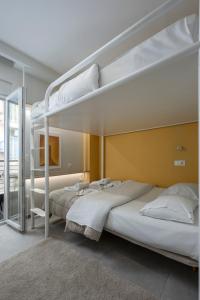 a bedroom with two bunk beds and a mirror at City Vibe-Siggrou 44 family in Thessaloniki