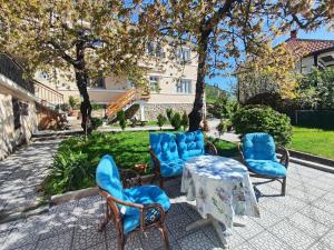 a group of chairs and a table in a yard at Guliban in Kruševo