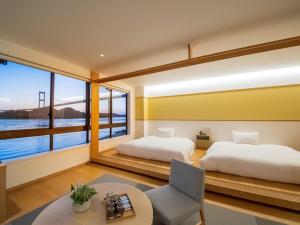 Tempat tidur dalam kamar di Glamprook Shimanami