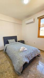 a bedroom with a bed with a towel on it at Central City Rooms in Larnaca +12 photos