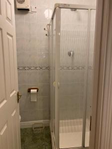 a shower with a glass door in a bathroom at Spacious Apartment, Enniscrone in Enniscrone +10 photos