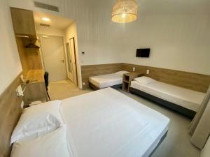 Ένα ή περισσότερα κρεβάτια σε δωμάτιο στο Hotel L'ondine