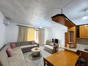 a living room with a couch and a table at Alex Apartments in Sarandë