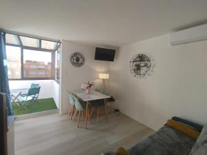 a living room with a table and chairs and a couch at Côté Marina in Gruissan