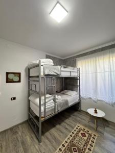 a room with two bunk beds and a table at Hostel Leon Berat in Berat