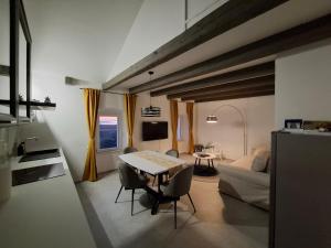 a kitchen and living room with a table and chairs at Tina's Sunset Haven in Ustrine