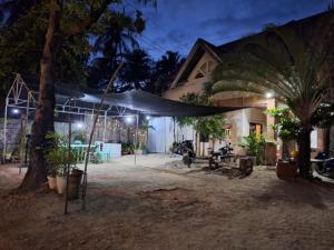 a tent outside of a house at night at Pagudpud Rinnovati in Pagudpud