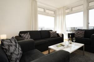 a living room with a couch and a table at Panorama Meerblick II in Staberdorf +17 photos