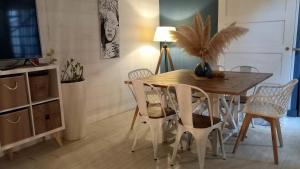 a dining room with a wooden table and chairs at Appartement duplex toit terrasse in Apt