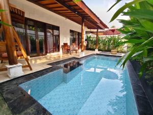 a swimming pool in the backyard of a house at Privat Pool Villa at Kuta in Kuta