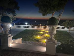 two white vases in a yard at night at Villa Nunziatella Badia in Trappeto