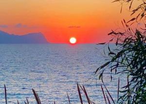 a sunset over a body of water with the sun at Villa Nunziatella Badia in Trappeto