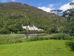 a large white building in the middle of a river at Stone Barn Cottage In Galway Countryside in Athenry