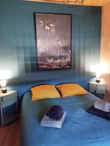 a bedroom with a bed with a hat on it at la ferme de la chanvriole in Mercuer