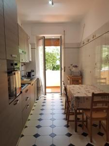 a kitchen with a table and chairs and a kitchen with a table and a table at la casa al mare in Pescara