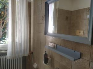 a bathroom with a sink and a mirror and a window at Civico 21-FreeParking in Vescovato +30 photos