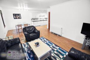 a living room with a couch and a table at Thistle Apartments - Bon-Accord Apartment in Aberdeen