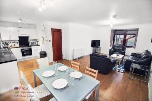 a kitchen and living room with a table and chairs at Thistle Apartments - Bon-Accord Apartment in Aberdeen +11 photos