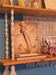 a wooden clock on a shelf on a wall at Arlind's Apartaments in Vlorë