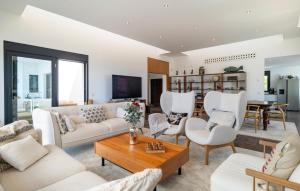 a living room with white furniture and a table at Casa Per in Marbella
