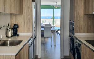 a kitchen with a sink and a dining room at Casa Cantal in Mojácar