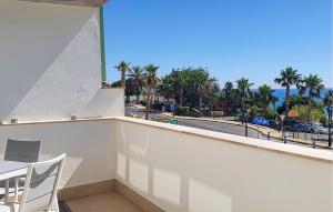 a balcony with a table and chairs and a view of a street at Casa Cantal in Mojácar