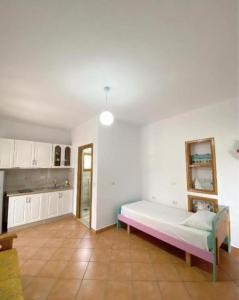 a living room with a bed and a kitchen at Arlind's Apartaments in Vlorë