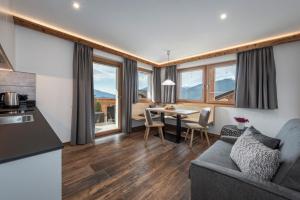 a kitchen and living room with a couch and a table at Obergasserhof in Rodengo