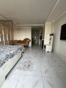a bedroom with a bed and a tiled floor at Effile view studio apartment in Lahore
