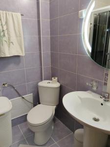 a bathroom with a toilet and a sink at D&D Apartman in Bar +9 photos