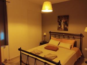 a bedroom with a large bed with yellow walls at Nova Ledeza NL in Igoumenitsa