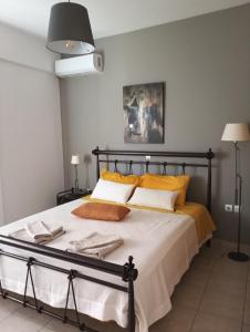a bedroom with a large bed with yellow pillows at Nova Ledeza NL in Igoumenitsa