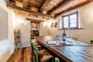 a dining room with a wooden table and chairs at Antica Dimora Cotai in Canale dʼAgordo +36 photos