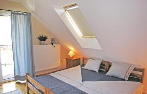 a bedroom with a large bed with a large window at Pelso apartman in Balatonalmádi