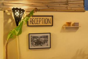 a sign on a wall that reads reception at Casa Voyager 'secret garden terrace' in Chefchaouen